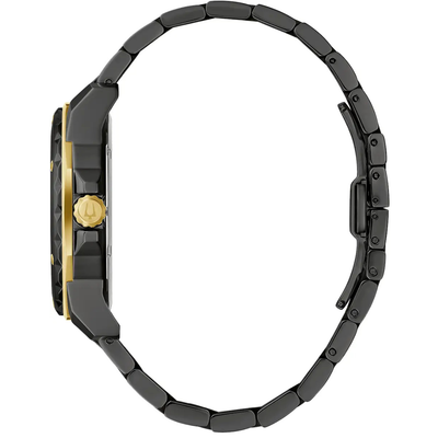 A close-up side view of a watch with a dark gunmetal gray link bracelet, a dark gunmetal case, and gold accents on the bezel and crown, set against a plain white background.
