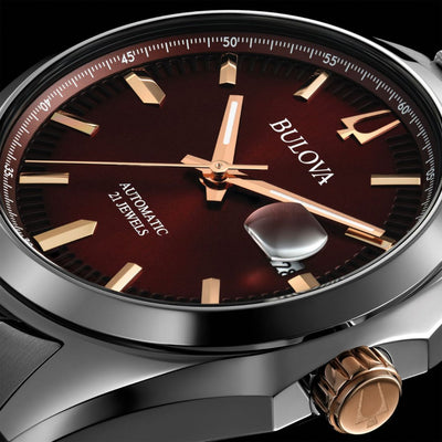 A Bulova men's watch with a silver-tone stainless steel bracelet and a burgundy dial with rose gold-tone accents.