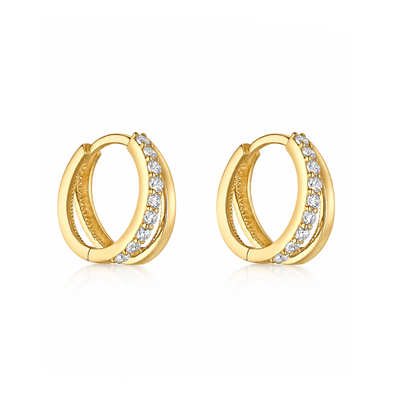 A pair of gold huggie hoop earrings with a row of clear pavé-set stones along the front, displayed on a clean white background.