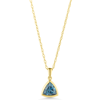 Gold necklace with a blue gemstone pendant on a white background