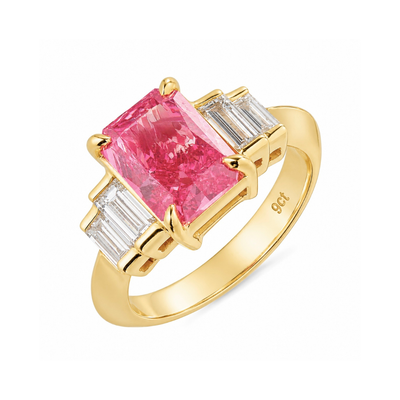 Gold ring with a pink gemstone and baguette diamonds on a white background