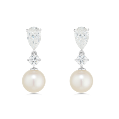 Pearl and diamond earrings on a white background