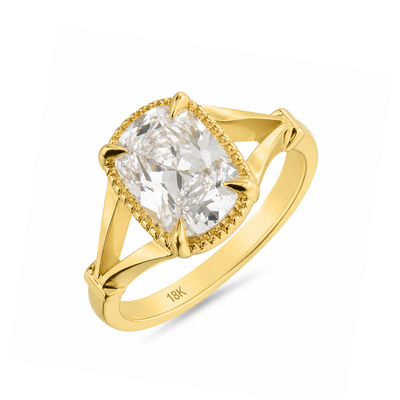 Gold ring with a large diamond on a white background