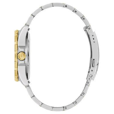 A silver-toned metal watch with a matching metal bracelet, shown from a side profile view. The watch case features a prominent gold-tone crown guard and a gold-tone crown, while the bracelet and case body are silver-tone stainless steel.