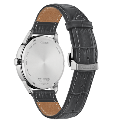 Citizen watch shown from the back, featuring a silver stainless steel case and a dark gray textured leather strap with white stitching and tan lining.