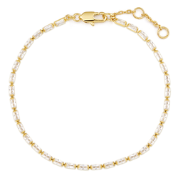 Gold and white beaded bracelet on a white background