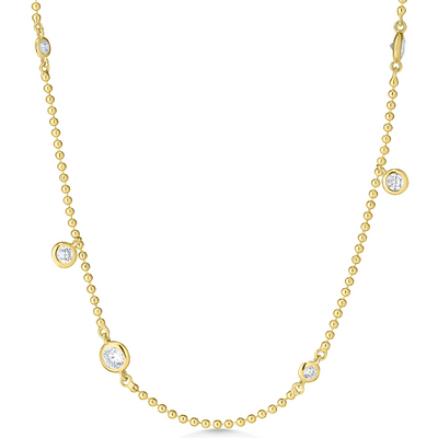 Gold necklace with small diamonds on a white background