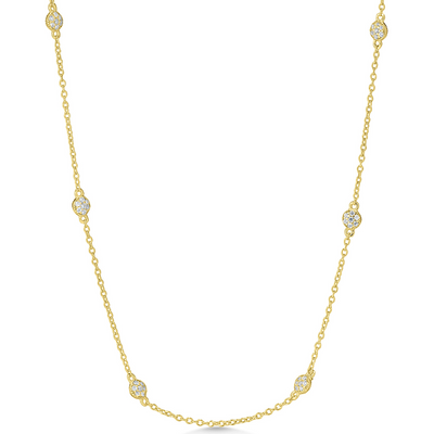 Gold necklace with diamond beads on a white background