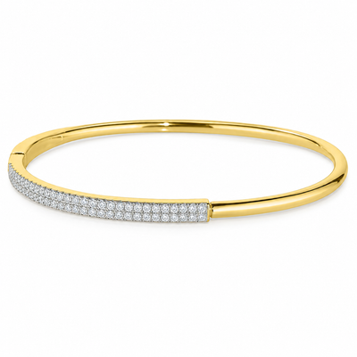 A gold bangle bracelet featuring a row of pavé-set clear stones along the front half, shown on a plain white background.