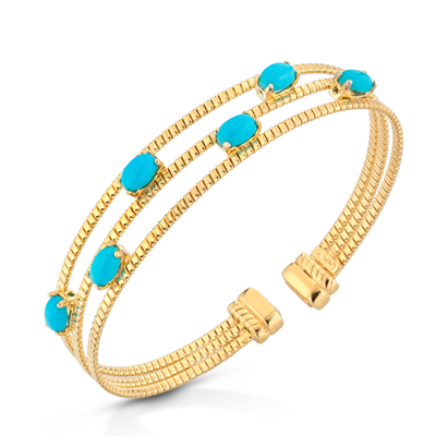 Gold bracelet with turquoise stones on a white background