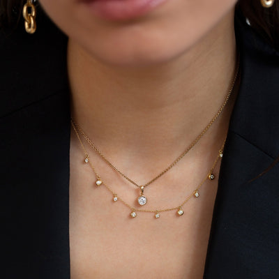 model wearing duo of diamond necklaces