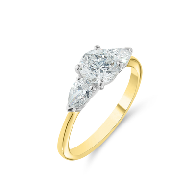 Gold ring with three diamond stones on a white background