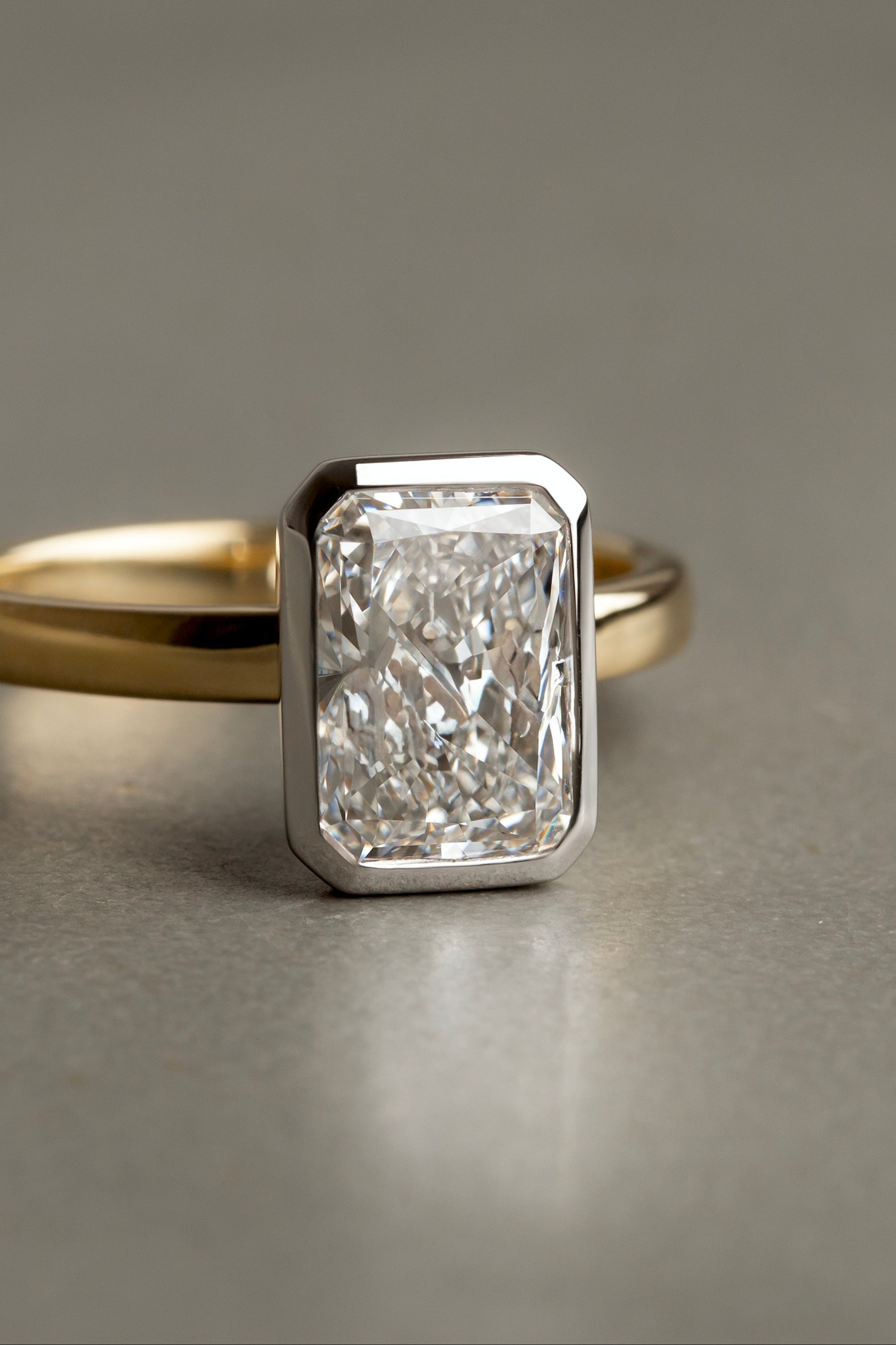 Gold ring with a large diamond on a gray background