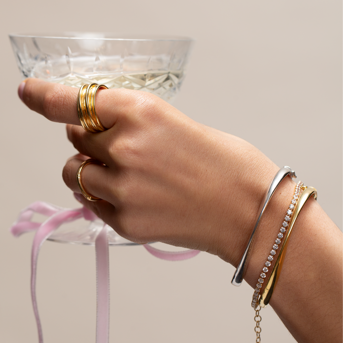 Hand holding a glass with a neutral background