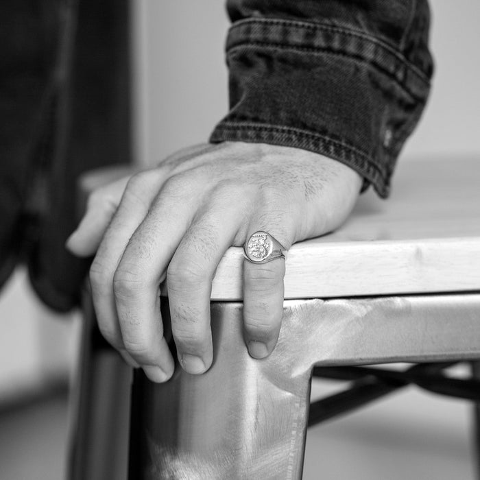 Person wearing a ring on a chair with a blurred background