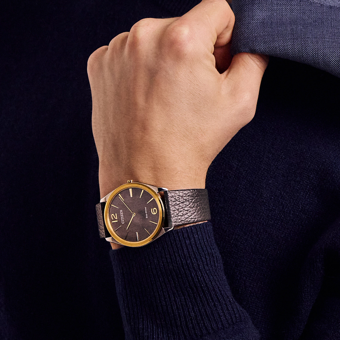 Man wearing a watch with a dark blue sweater