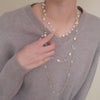 Model wearing necklace stack