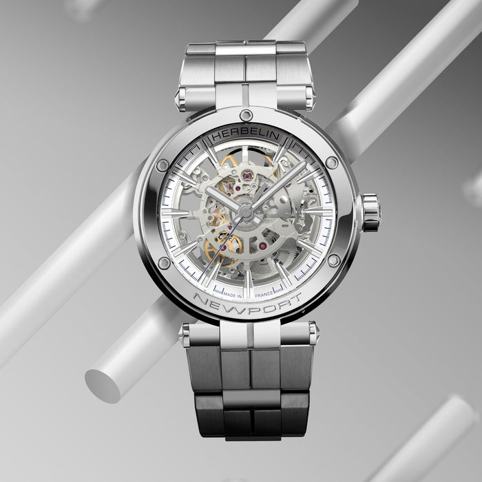 Silver watch with a detailed face on a gray background