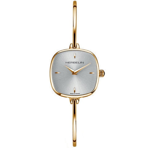 A gold-toned Herbelin Fil bangle watch with a square case, mother-of-pearl dial, and matching gold-toned bracelet.