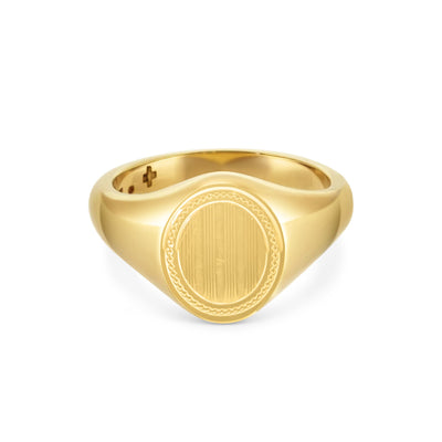 A yellow gold signet ring with an ornate, oval-shaped top, displayed against a white background.