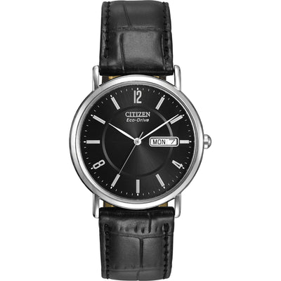 A men's Citizen Eco-Drive watch with a black strap and dial, featuring a day-date indicator and Arabic numerals.