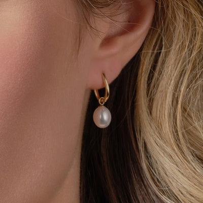 Gold pearl hoops on model 